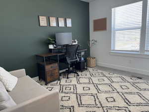 Office with baseboards and carpet