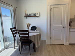 Dining room featuring light wood finished floors and baseboards