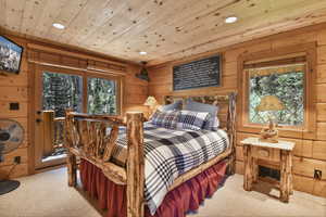 Bedroom featuring carpet, recessed lighting, wood walls, and wood ceiling