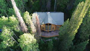 View from above of property featuring a heavily wooded area