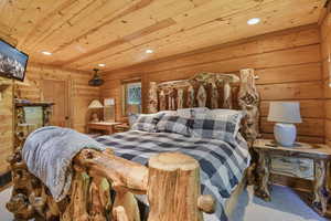 Carpeted bedroom with wood ceiling and recessed lighting