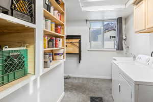 Laundry area with storage shelves, workbench and washer and dryer