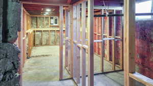 Unfinished basement space, with already framed walls providing storage space or room to grow!