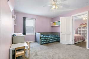 Bedroom #2 featuring carpeted flooring, walk in closet and ceiling fan