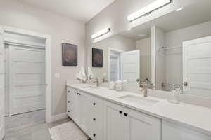 Bathroom featuring double vanity and a shower