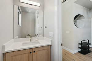 Bathroom featuring wood finished floors and vanity