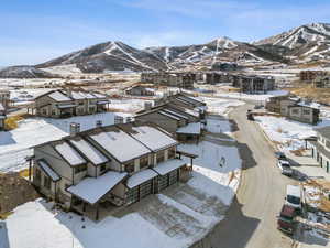 Snowy aerial view with a mountain view and a residential view