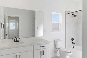 Bathroom with vanity, washtub / shower combination, and healthy amount of natural light