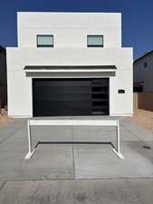 View of rear of property, a garage, and driveway