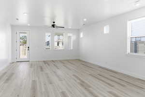 Foyer entrance featuring light wood-type flooring, ceiling fan, and recessed lighting