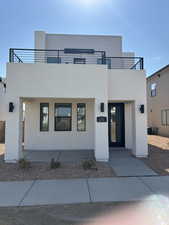 View of front of property featuring covered porch and stucco siding