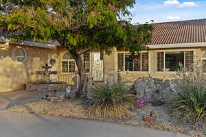 View of front of house featuring stucco siding and a tile roof