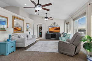 Living area featuring vaulted ceiling, carpet, a ceiling fan, and recessed lighting