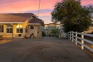 Back of house featuring a tiled roof and stucco siding