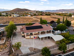 Aerial view of property and surrounding area featuring mountains