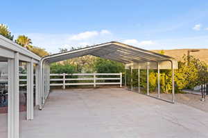 View of patio featuring a carport and concrete driveway