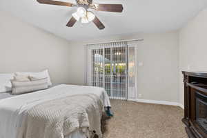Carpeted bedroom featuring a ceiling fan and baseboards