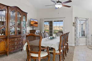 Dining area with ceiling fan and light tile patterned flooring