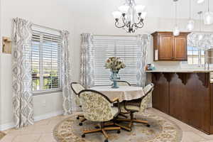 Dining area featuring a chandelier and light tile patterned floors