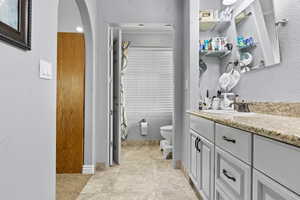 Bathroom featuring vanity and a textured wall