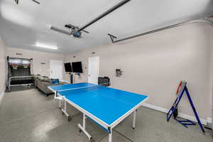 Playroom featuring a textured ceiling and a garage