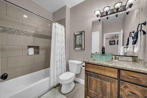 Full bathroom with vanity and shower / bath combo with shower curtain