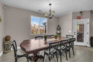 Dining space with a chandelier and baseboards