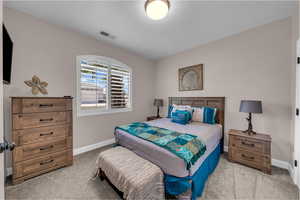 Carpeted bedroom with baseboards