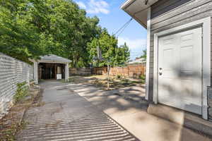 Fenced backyard with a storage unit
