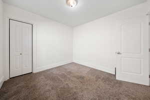 Unfurnished bedroom with carpet and a closet