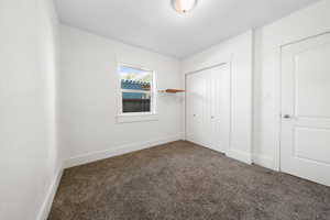 Unfurnished bedroom with carpet and a closet