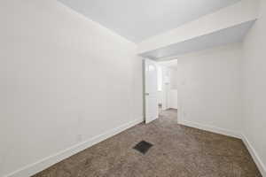 Empty room with carpet and baseboards