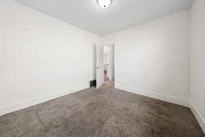 Empty room featuring light carpet