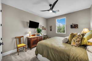Bedroom featuring light carpet and ceiling fan