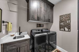 Laundry area featuring washing machine and dryer and cabinet space