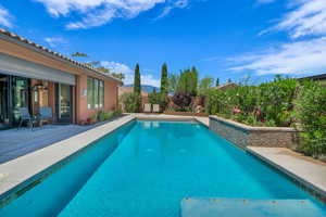 View of swimming pool with a patio area and a fenced backyard