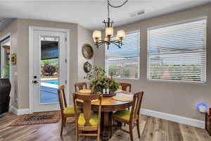Dining area featuring wood finished floors and a chandelier