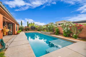 View of swimming pool featuring a patio area and a fenced backyard