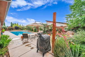 View of pool with area for grilling, a patio area, and a fenced backyard