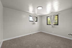Carpeted empty room with baseboards