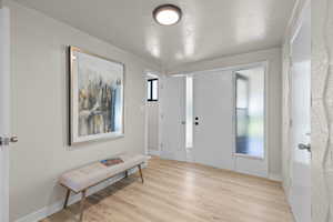 Entrance foyer featuring light wood-style floors