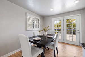 Dining room featuring light wood-style floors and baseboards