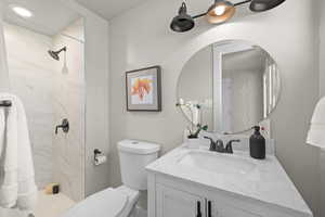 Bathroom with vanity and tiled shower