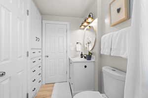 Full bath with vanity and wood finished floors