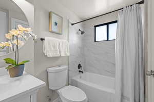 Full bathroom featuring shower / bath combo and vanity