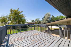 Wooden terrace with a fenced backyard