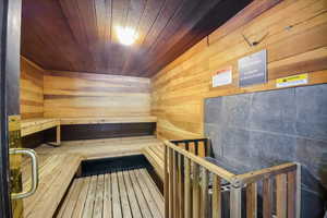 Sauna featuring wood ceiling and wood walls