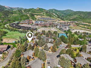 Aerial view of property's location with a mountain backdrop