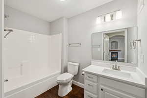 Full bath featuring vanity, wood finished floors, and shower / bathtub combination