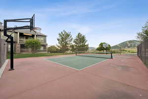 View of tennis court with community basketball court